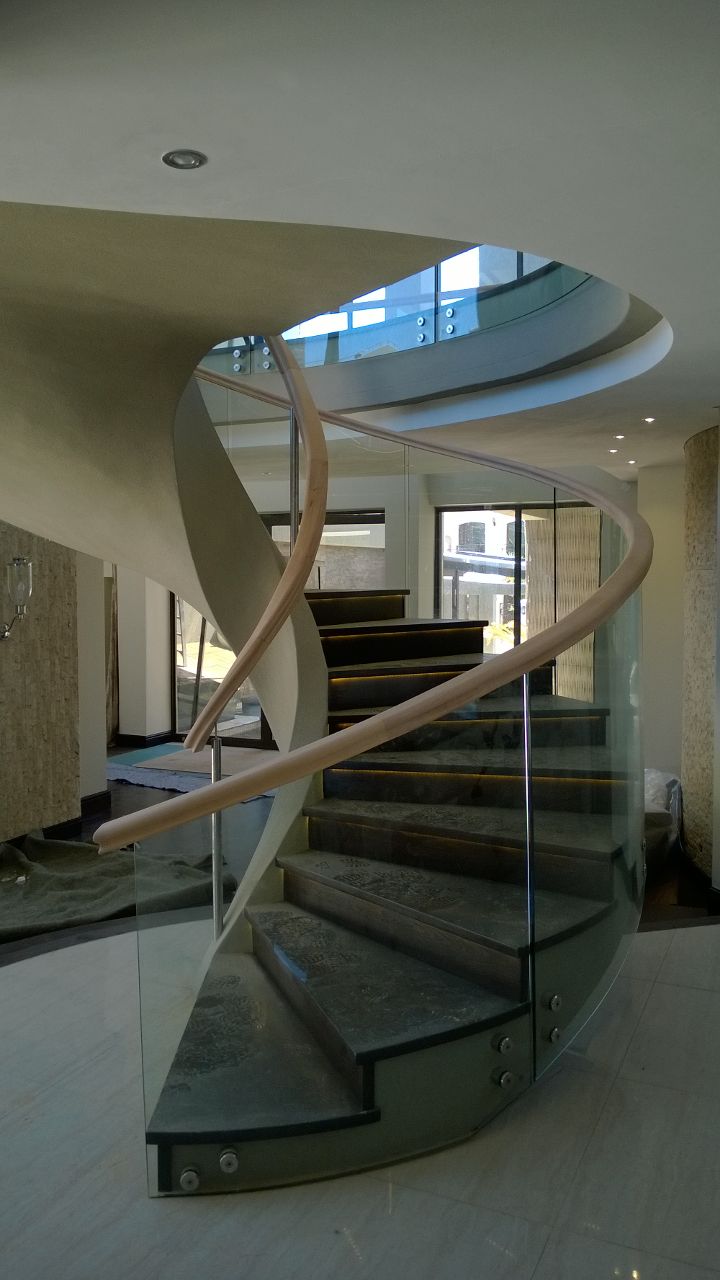 Glass balustrades with hand made wooden spiral handrails. 